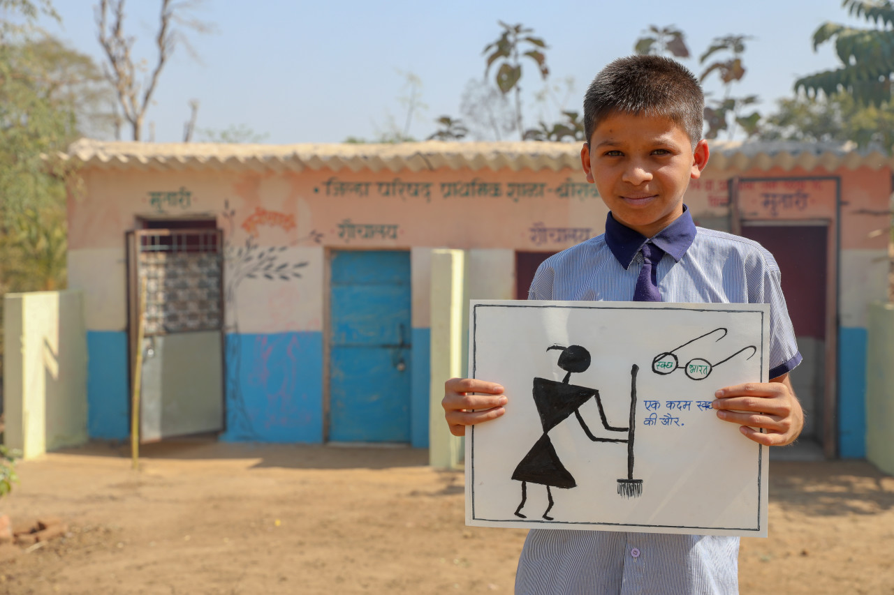 Child holding a drawing