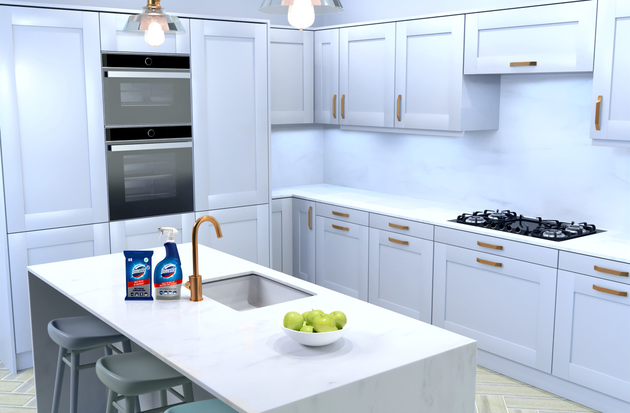 A clean kitchen with domestos surface wipes and disinfectant spray placed on the kitchen worktop