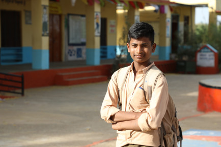 Boy in front of a school